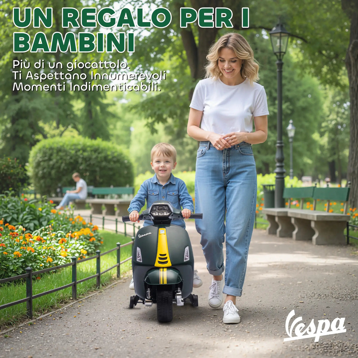 Bambino su Vespa elettrica verde nel parco